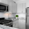 bright kitchen with stainless steel appliance and granite counter