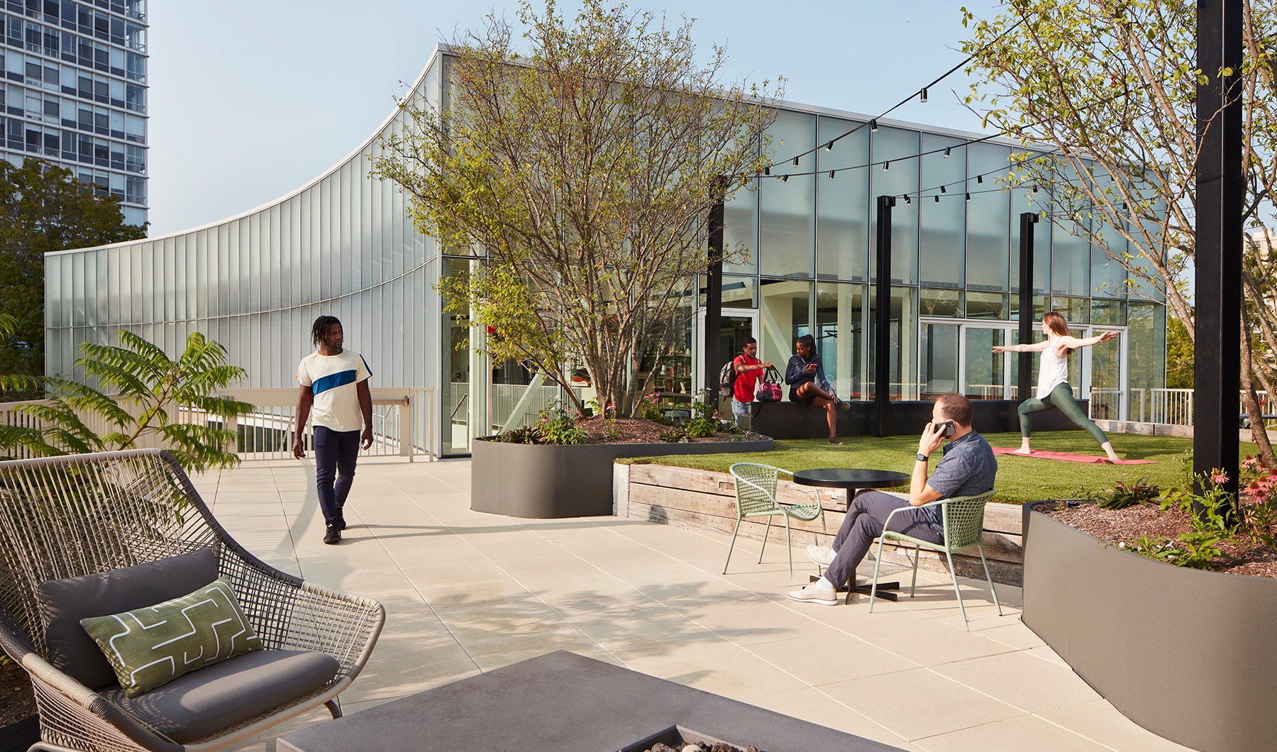 Outside patio with people relaxing and also yoga Outside patio with people relaxing and also yoga